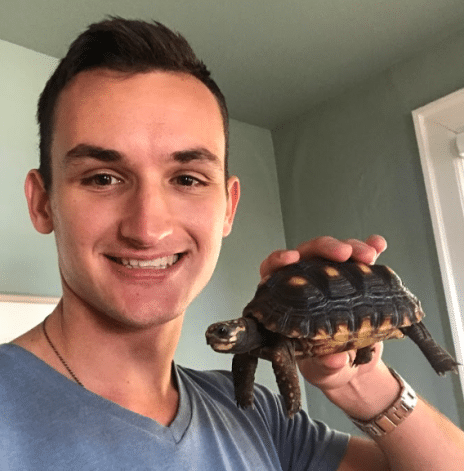 holding a red footed tortoise